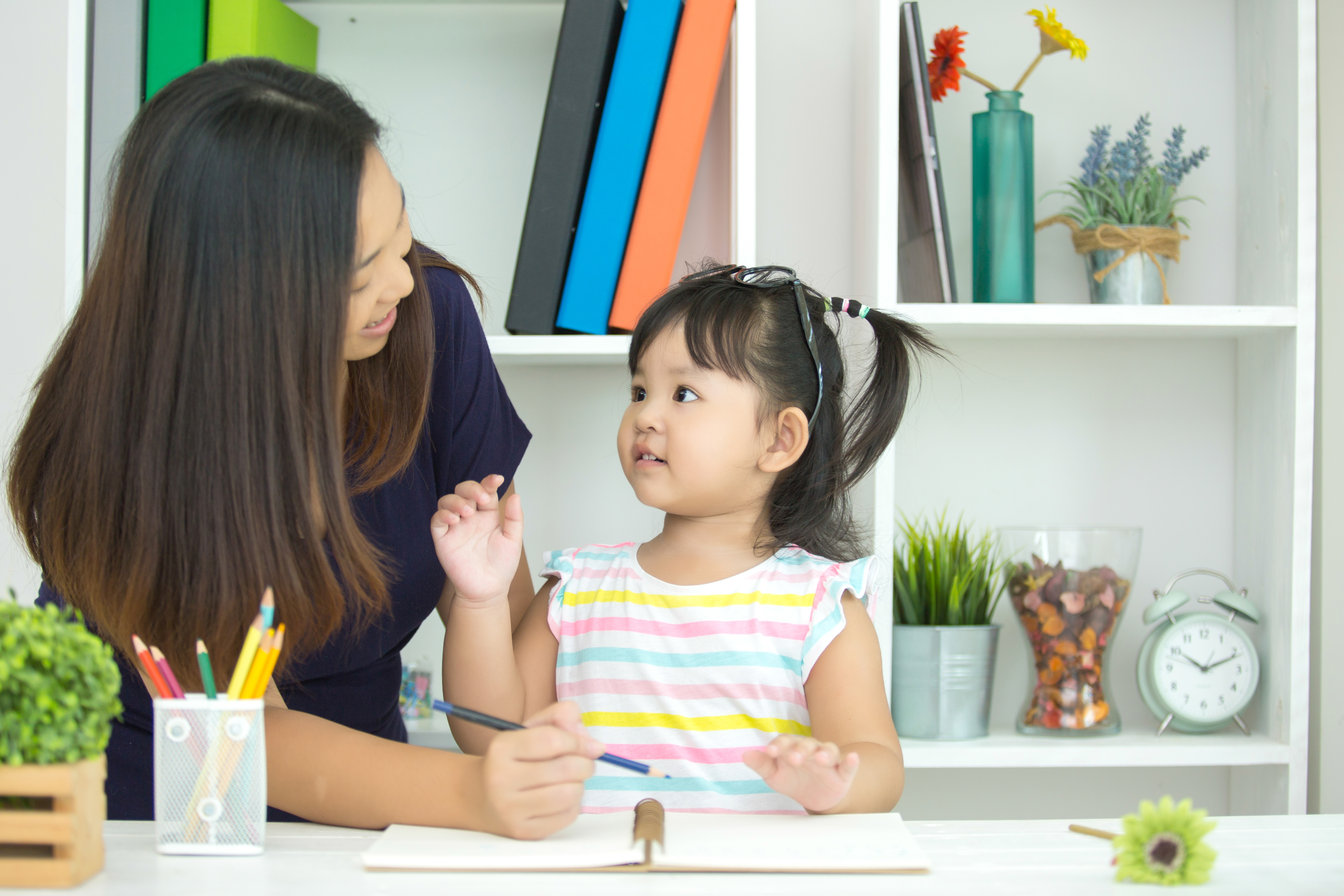 A girl and her ABA therapist during 1:1 in-home ABA therapy