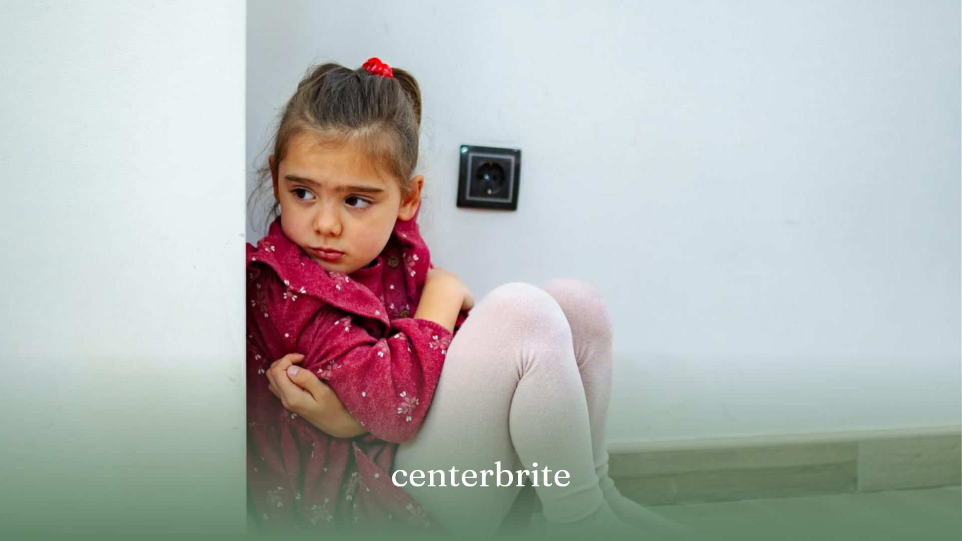 A girl sitting alone in a corner