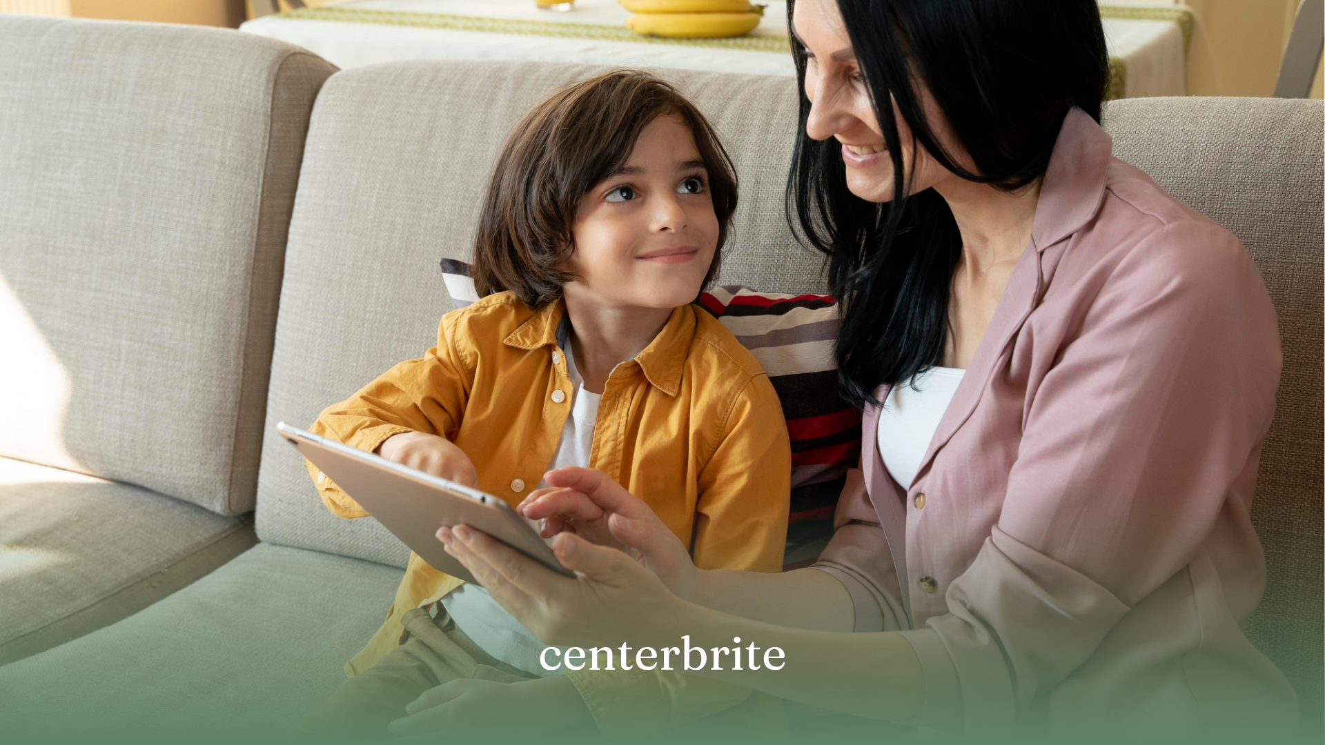 A child and his mother communicating with each other on a couch