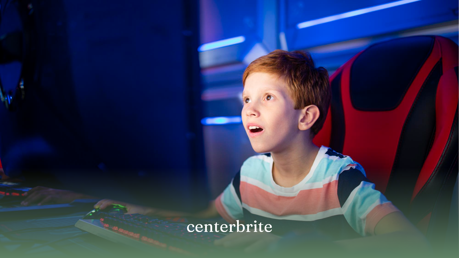 A kid sitting on a gaming chair playing Minecraft on a computer