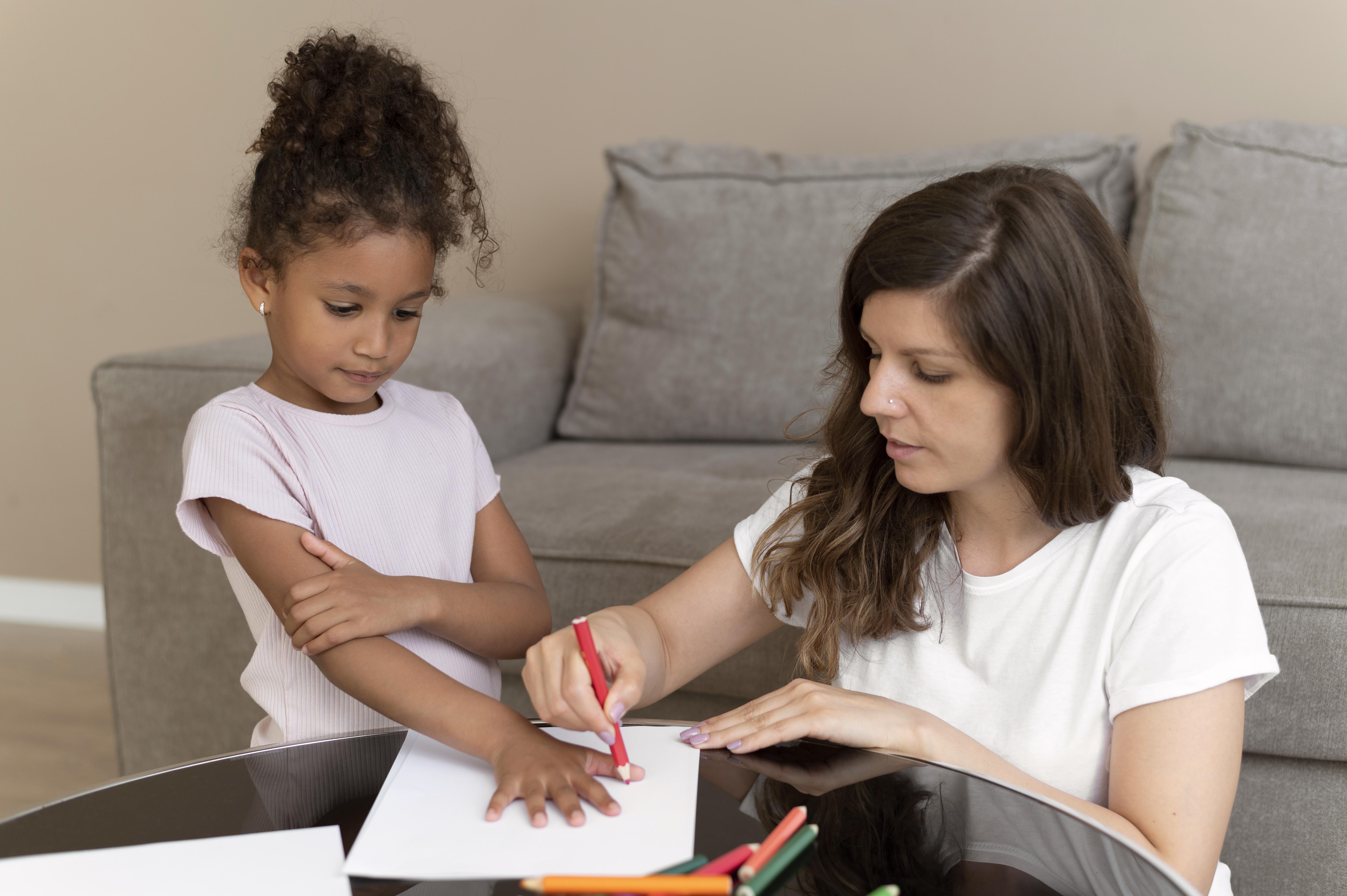 A kid and an ABA therapist during 1:1 ABA therapy
