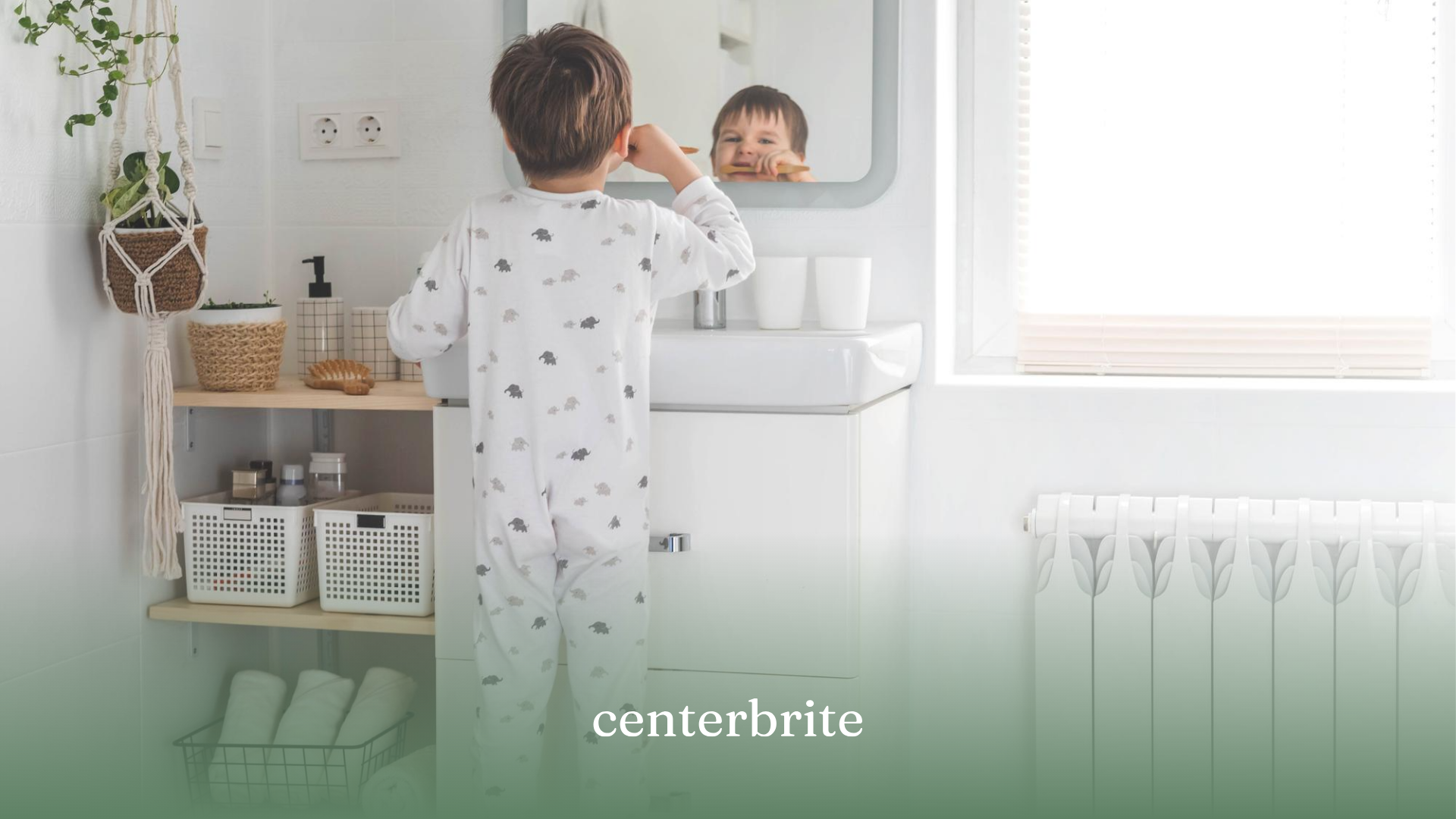 A kid standing in front of a sink and mirror, brushing his teeth