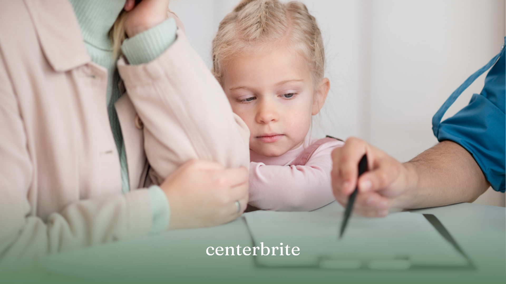 A kid holding her mom while she talks to an ABA therapist regarding documents