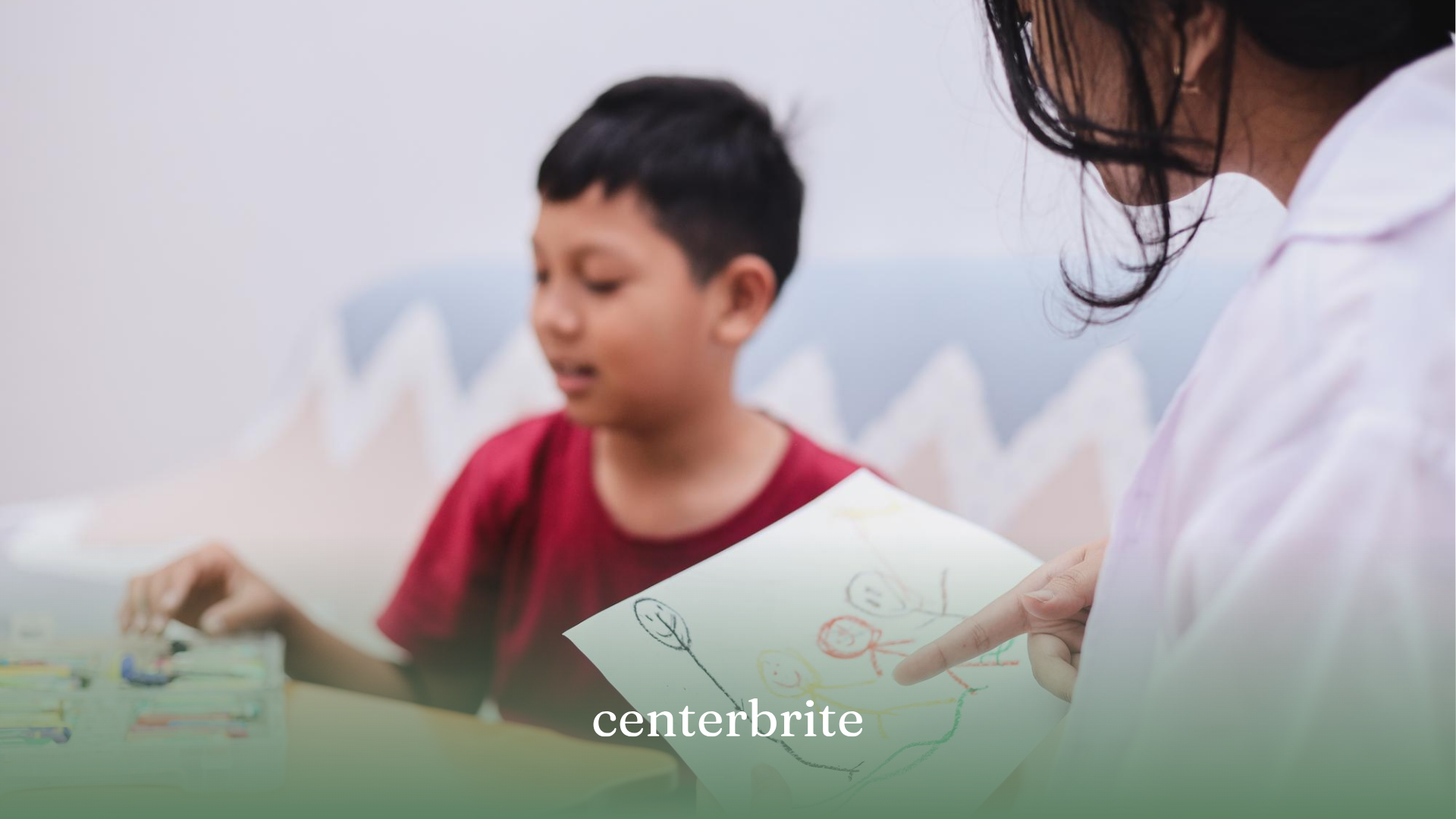 A BCBA holding a drawing made by a child during autism diagnosis