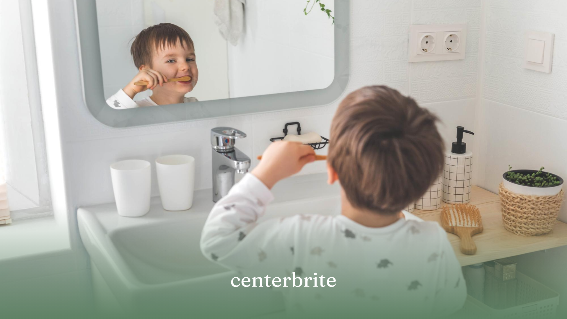 A child looking at himself at the mirror while brushing his teeth